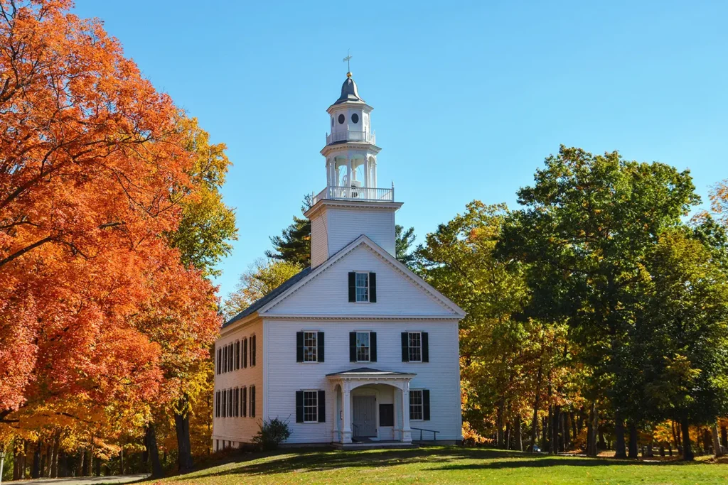 Shirley Meeting House surrounded by autumn foliage